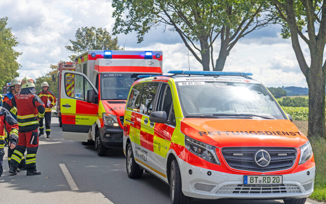 Einsatzfahrzegeuge des Rettungsdienstes und Feuerwehrleute am Einsatzort zwischen Mistelbach und Mistelgau.