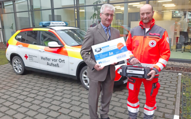 Harald Bergmann, Regionalleiter der VR Bank Bayreuth-Hof (l.), überreichte den neuen Defibrillator an Stefan Endlich (r.) von den Helfer-vor-Ort (HvO) des BRKs in Aufseß. Finanziert wurde das Gerät über die Crowdfunding- Plattform „Viele helfen mehr“ und der VR Bank Bayreuth-Hof. Bild: VR Bank Bayreuth-Hof.